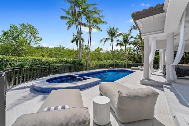 view of pool featuring a patio area, a fenced backyard, and a pool with connected hot tub