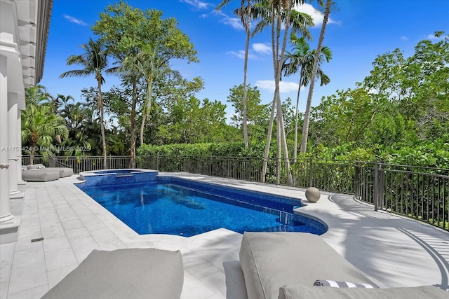 view of pool featuring a patio, a fenced backyard, and a pool with connected hot tub