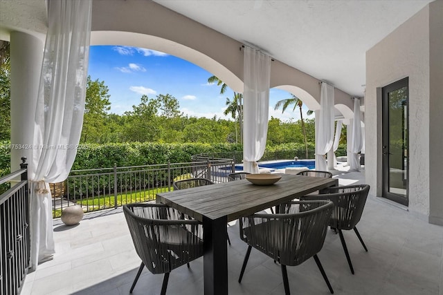 view of patio / terrace featuring outdoor dining space and a fenced in pool