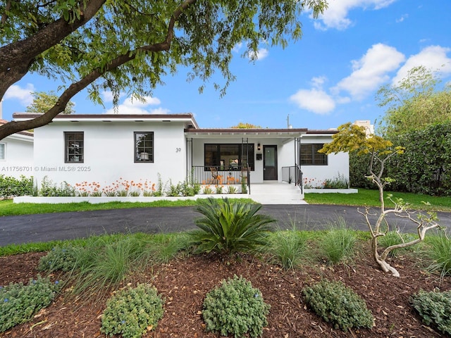 view of front of home with a porch and stucco siding