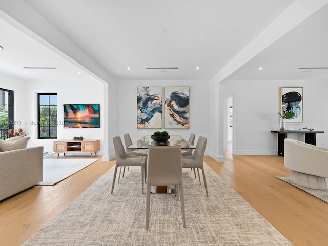 dining room featuring light wood-style flooring, recessed lighting, and baseboards