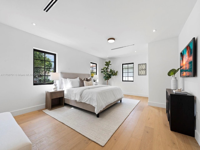 bedroom featuring light wood-type flooring, baseboards, and recessed lighting