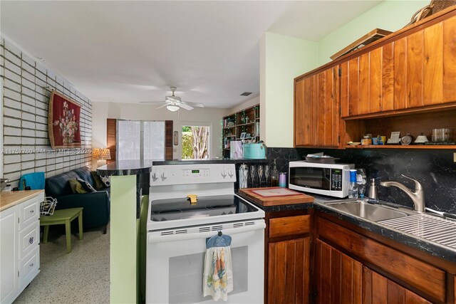 kitchen featuring brown cabinets, electric range, decorative backsplash, a sink, and ceiling fan