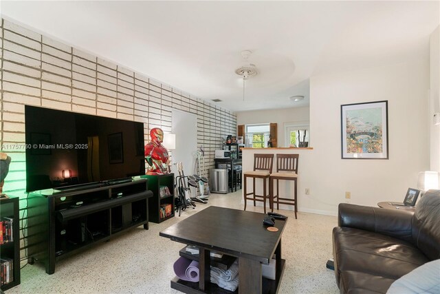 living room with speckled floor and baseboards