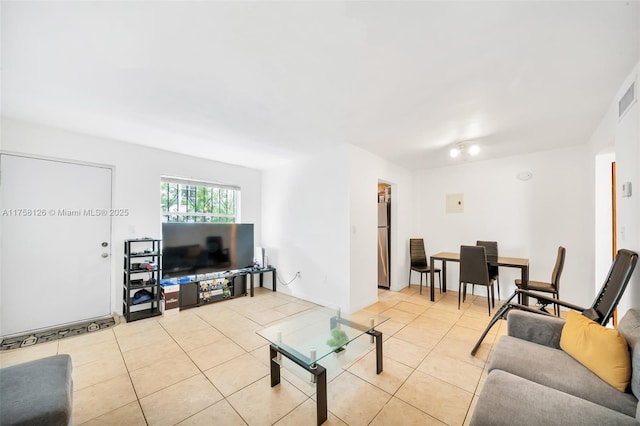 living area with tile patterned flooring and visible vents