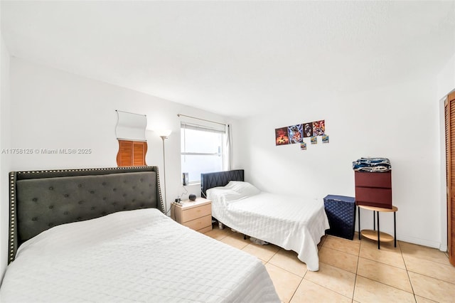 bedroom featuring light tile patterned flooring