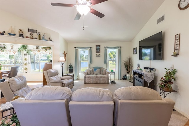 living area featuring light colored carpet, visible vents, and vaulted ceiling