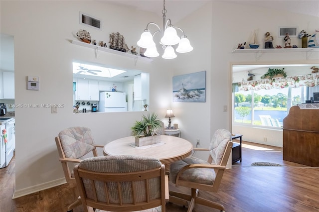 dining area with wood finished floors, visible vents, and baseboards