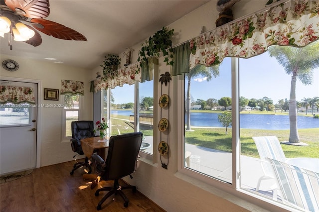 office area with lofted ceiling, ceiling fan, a water view, and wood finished floors