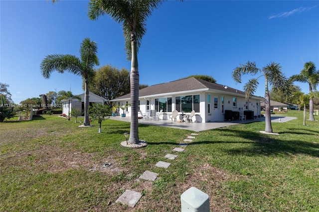 back of house featuring a yard, central AC, a patio, and stucco siding