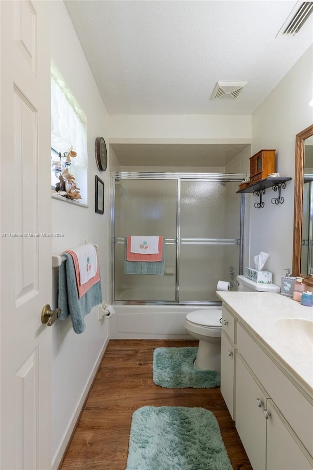 bathroom featuring visible vents, vanity, and wood finished floors