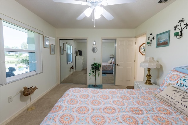 bedroom with multiple closets, carpet floors, baseboards, and a ceiling fan