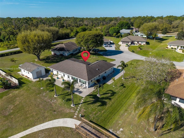 birds eye view of property featuring a wooded view