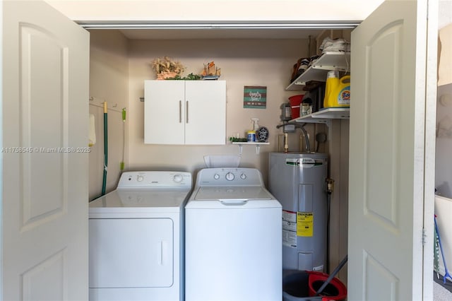 washroom featuring laundry area, separate washer and dryer, and electric water heater