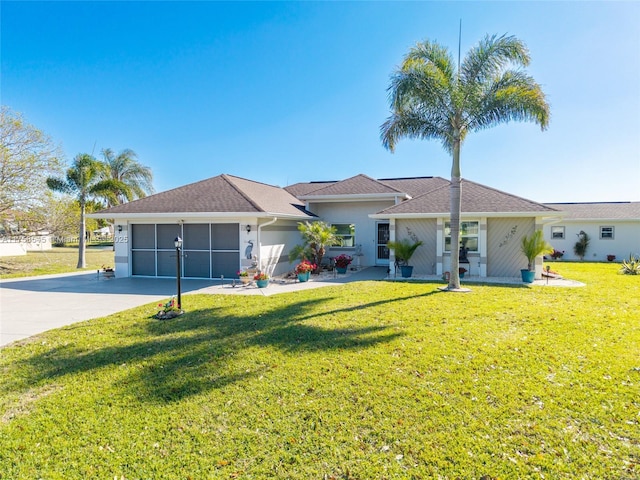 single story home featuring a garage, concrete driveway, a front lawn, and stucco siding