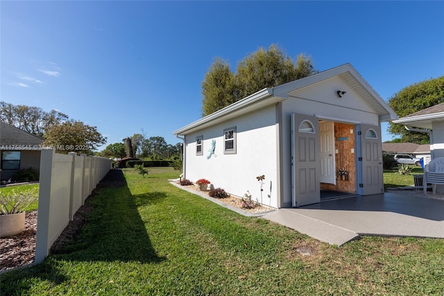 view of outbuilding featuring fence