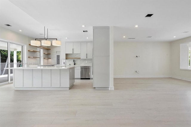 kitchen featuring a sink, plenty of natural light, tasteful backsplash, and dishwasher