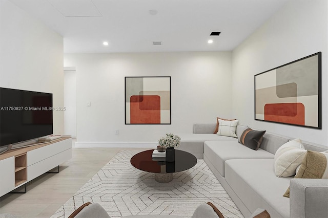 living room featuring baseboards, light wood finished floors, visible vents, and recessed lighting