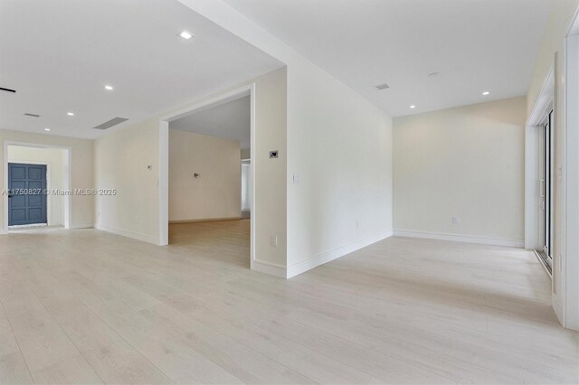 unfurnished room featuring recessed lighting, visible vents, light wood-style flooring, and baseboards