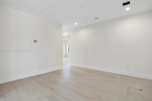 unfurnished room featuring light wood-type flooring, baseboards, and recessed lighting