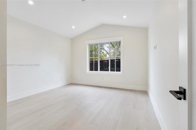 empty room featuring light wood finished floors, baseboards, vaulted ceiling, and recessed lighting