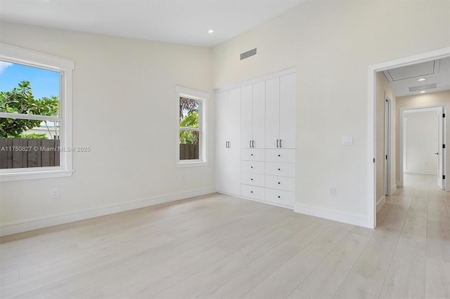 unfurnished bedroom with visible vents, baseboards, light wood-style flooring, a closet, and recessed lighting