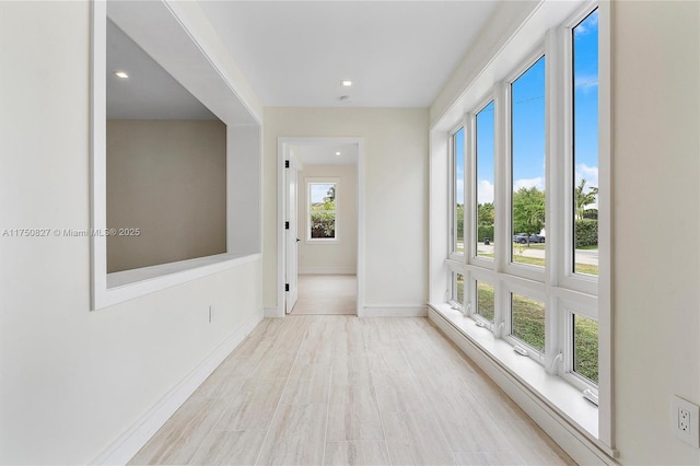 interior space with recessed lighting and baseboards