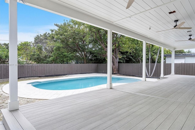 view of pool with a fenced backyard, a deck, ceiling fan, and a fenced in pool