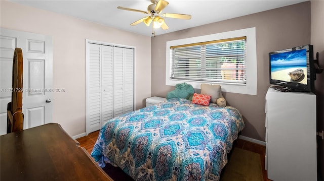 bedroom featuring a ceiling fan, a closet, and baseboards