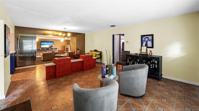 tiled living area with a chandelier, visible vents, and baseboards