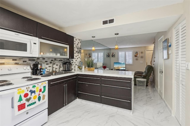 kitchen with white appliances, visible vents, a sink, and marble finish floor