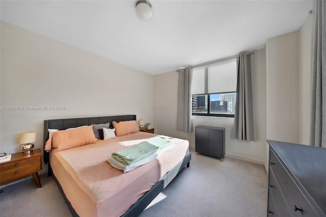 bedroom with light carpet and baseboards