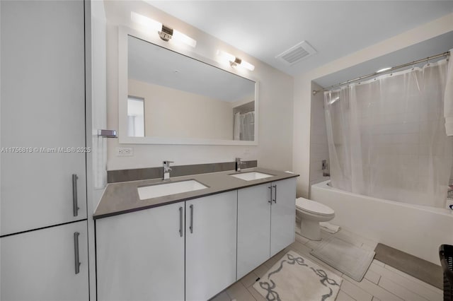 full bathroom featuring shower / tub combo, toilet, visible vents, and a sink