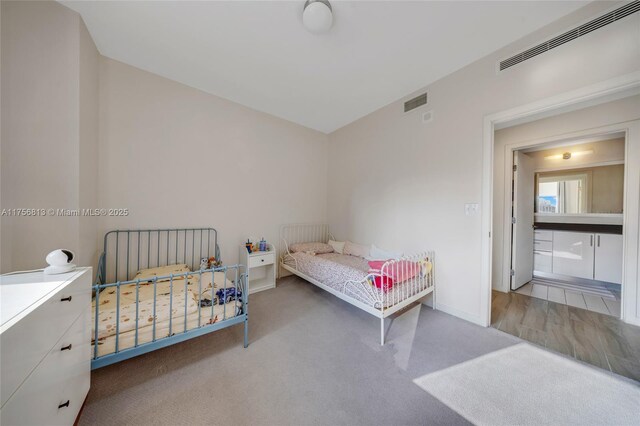 carpeted bedroom with visible vents and baseboards