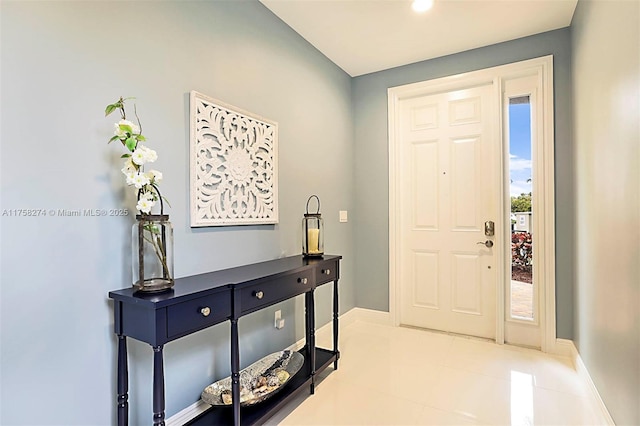 foyer featuring baseboards