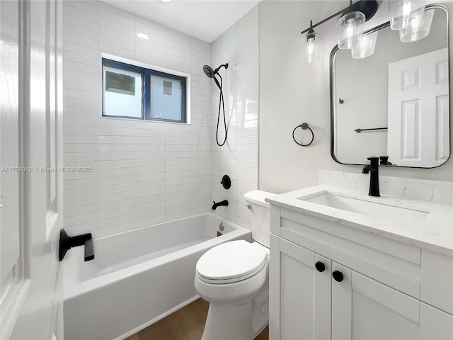 bathroom with vanity, toilet, wood finished floors, and shower / bathtub combination