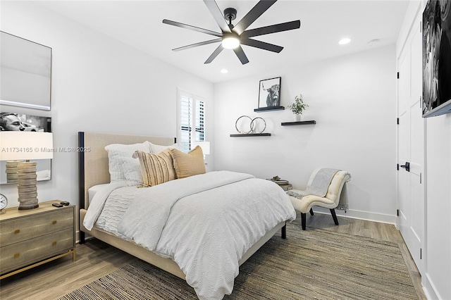 bedroom with a ceiling fan, recessed lighting, baseboards, and wood finished floors