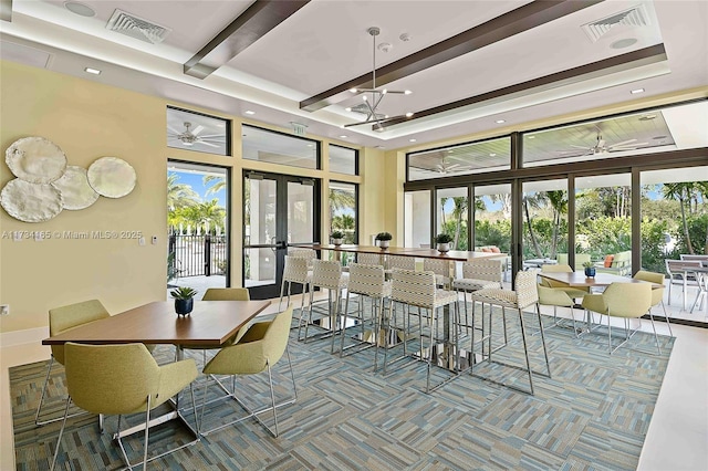 dining room featuring a tray ceiling, french doors, beamed ceiling, and visible vents