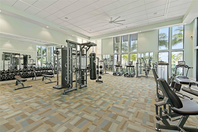 gym with carpet, visible vents, and a high ceiling