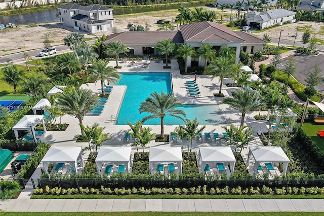 pool featuring a residential view, a patio area, and fence