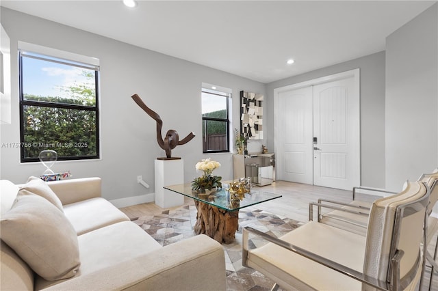 living room featuring plenty of natural light, recessed lighting, baseboards, and light wood-type flooring