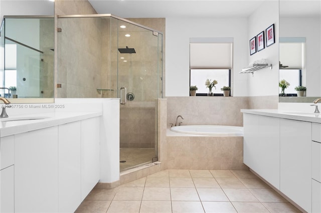 bathroom with a sink, a garden tub, a shower stall, and tile patterned floors