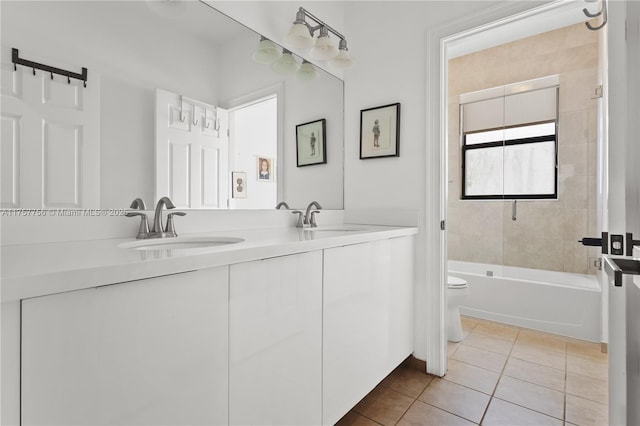 full bath featuring tile patterned floors, double vanity, toilet, and a sink