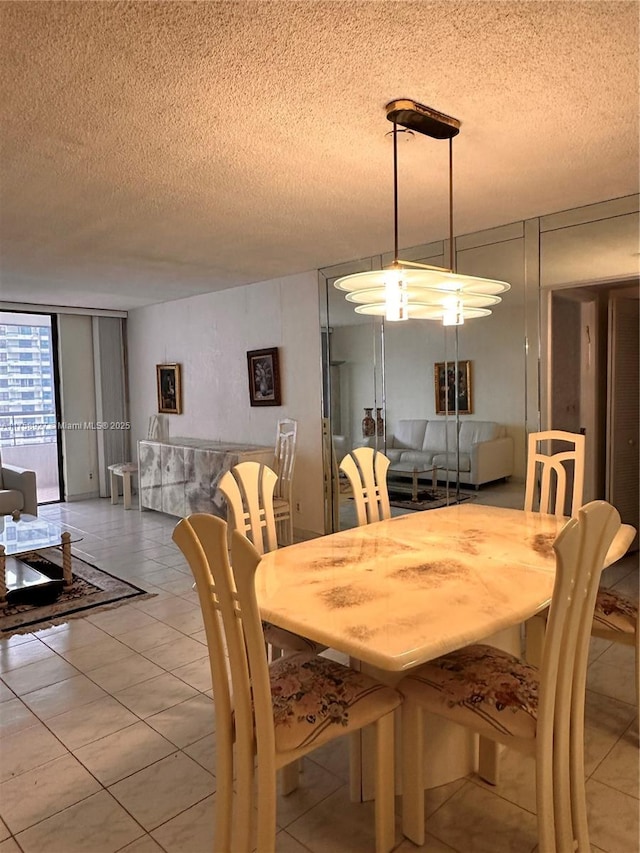 tiled dining room with a wall of windows and a textured ceiling