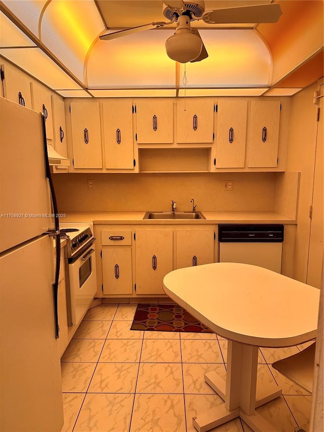 kitchen with light countertops, marble finish floor, white appliances, a ceiling fan, and a sink