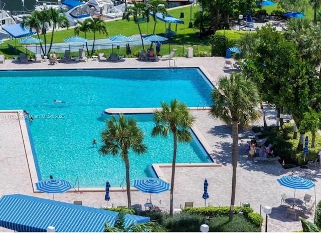 pool featuring a patio and fence