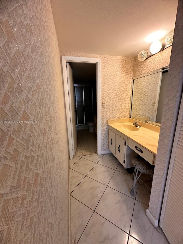 600 Three Islands Blvd Unit 1015, Hallandale Beach, FL 33009 - bathroom featuring vanity, wallpapered walls, and marble finish floor