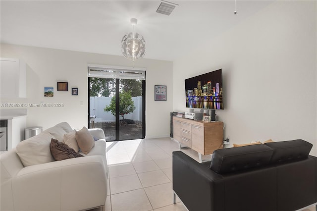 living room with visible vents, baseboards, and light tile patterned floors