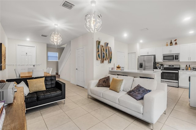 living area featuring light tile patterned floors, visible vents, and recessed lighting