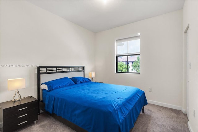 bedroom with carpet and baseboards